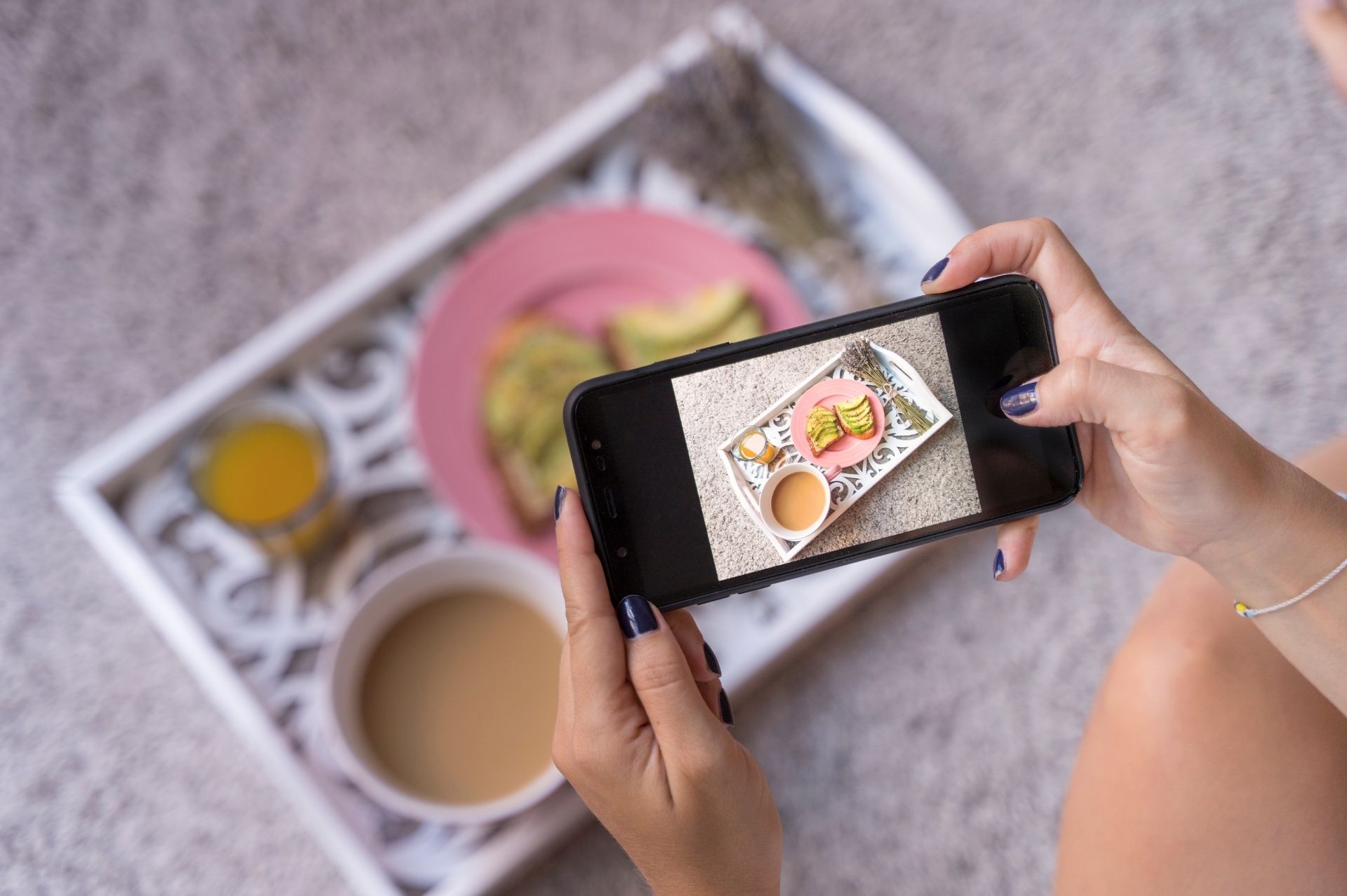 A person taking a picture of food with a phone