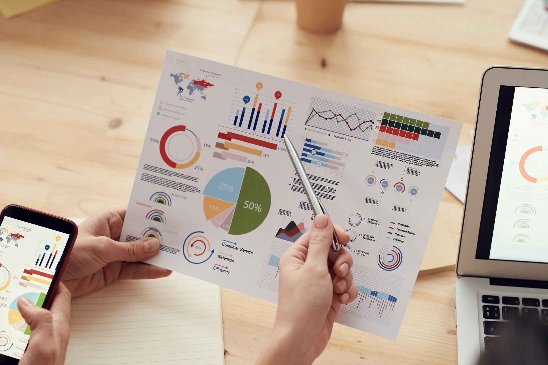 Person pointing at a chart with a pen