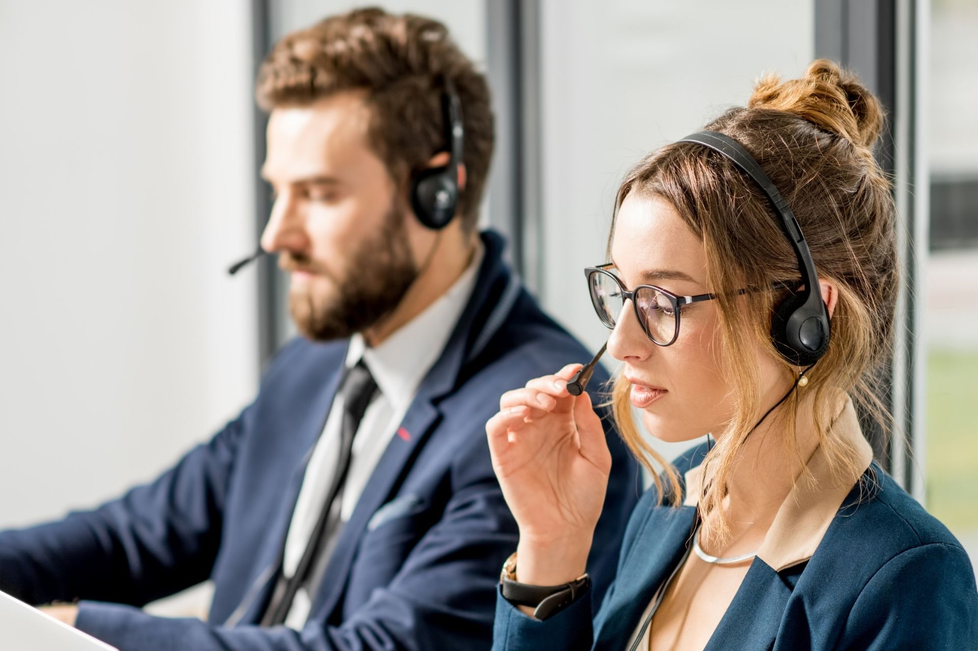 Two people talking on headsets